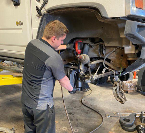 Mechanic from CH Auto Repair doing tire alignment